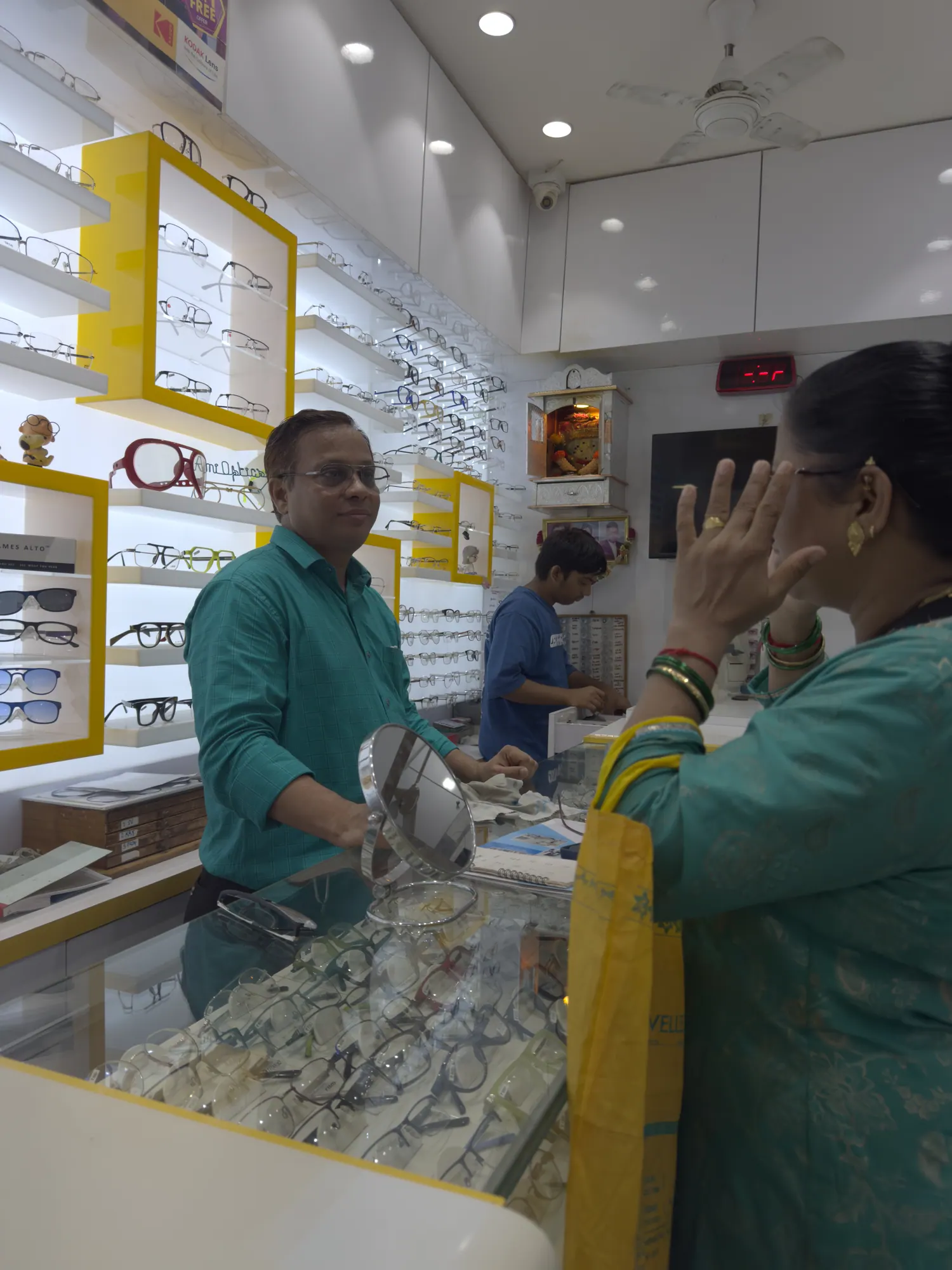 Jatin Vora talking a customer through their options at the counter of Ami Optics