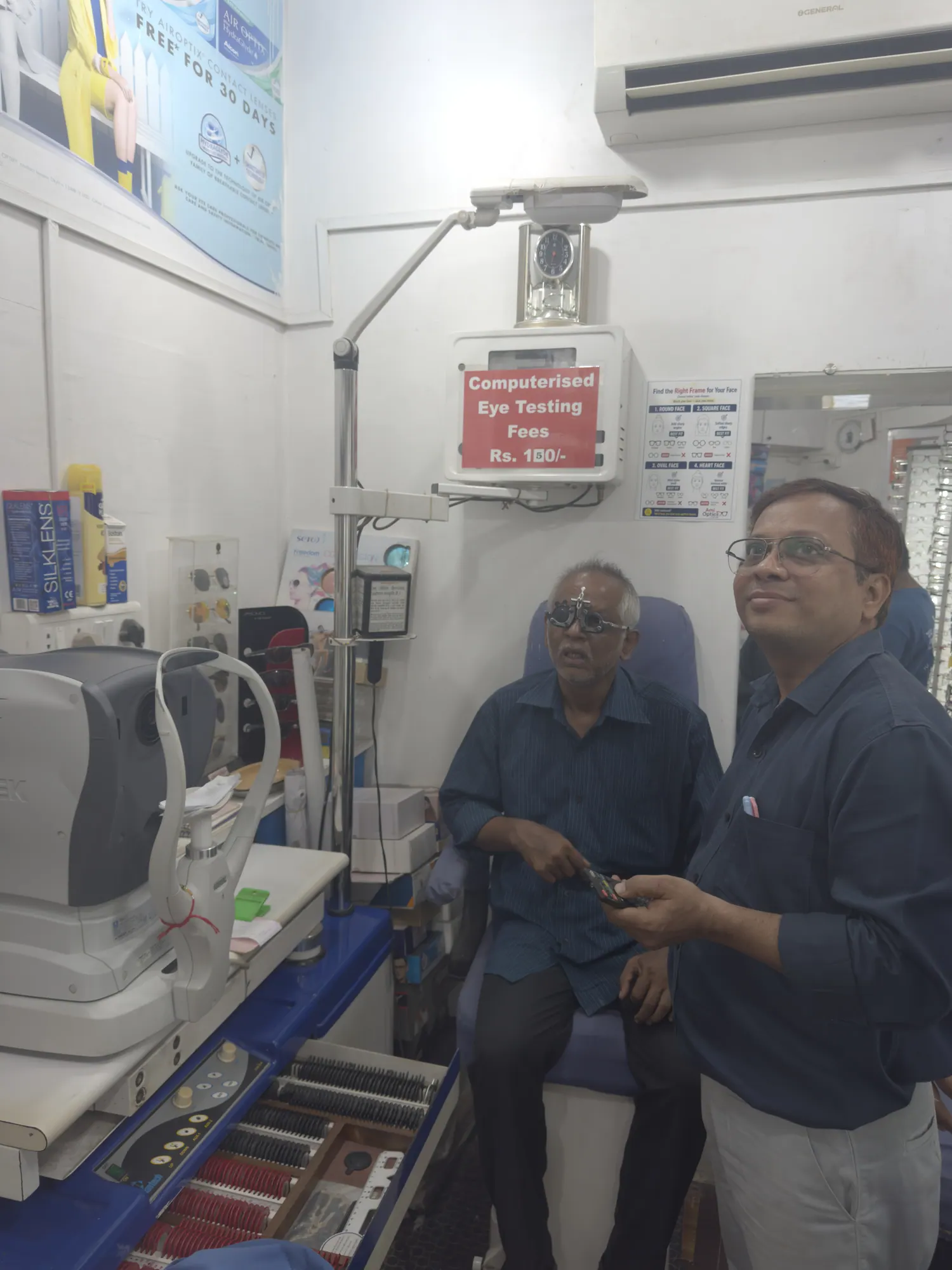 Jatin Vora checking a customer's vision with a trial frame in the eye testing room at Ami Optics
