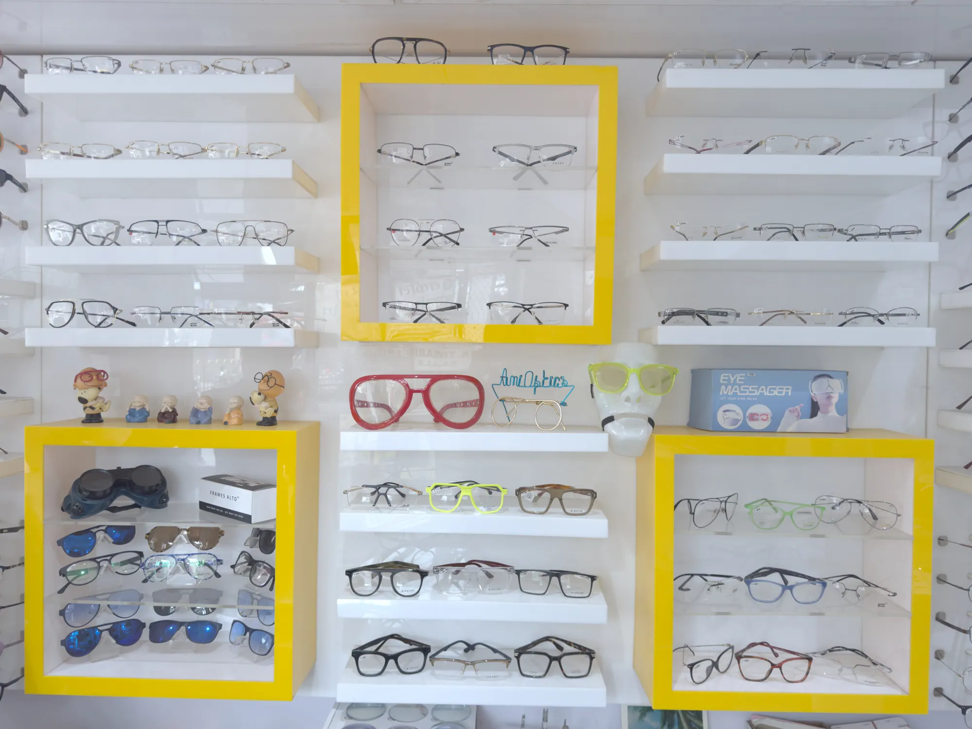 Colourful children's frames and toy figures on the display wall at Ami Optics