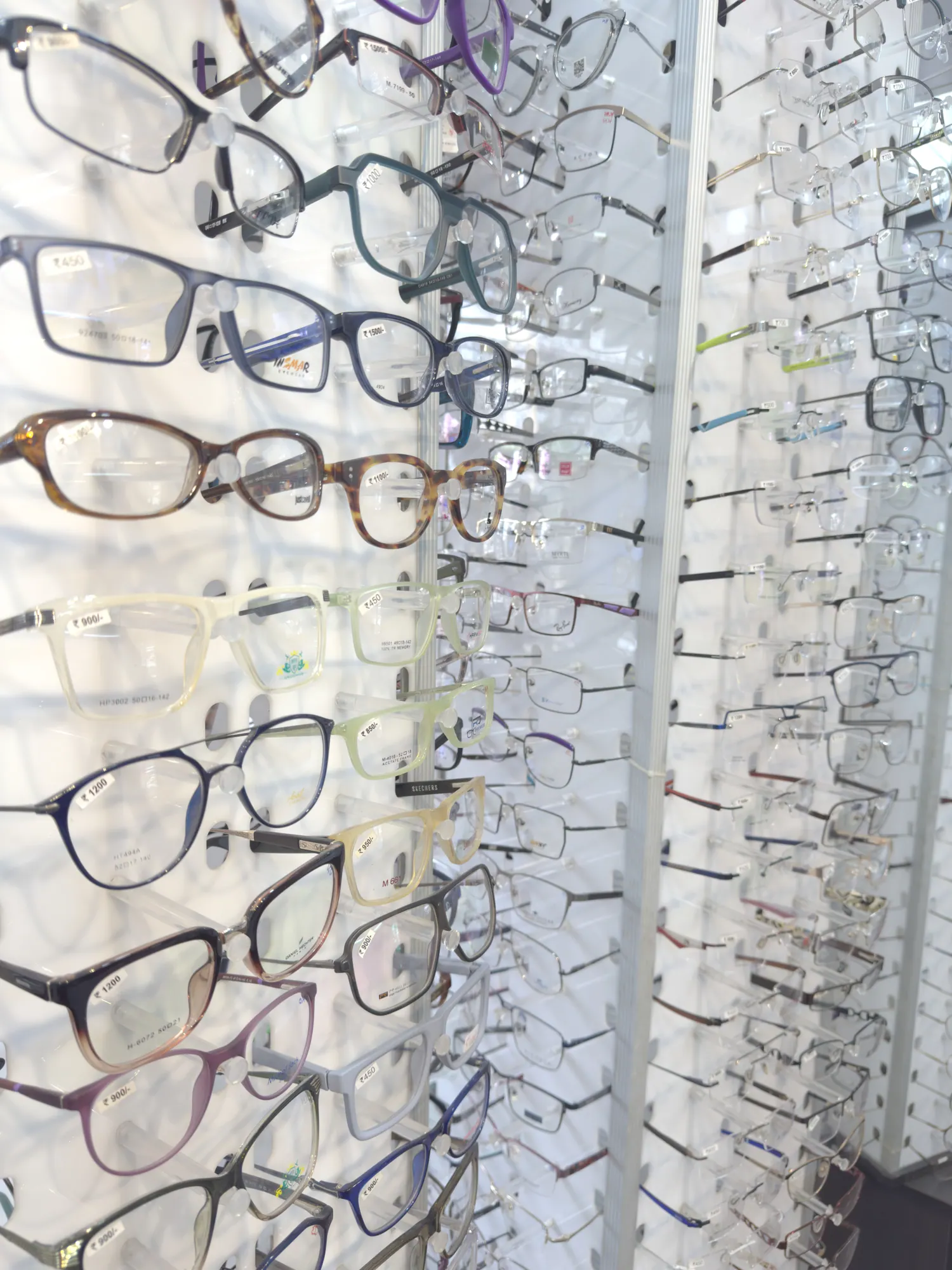 A close view of acetate and metal spectacle frames on display at Ami Optics