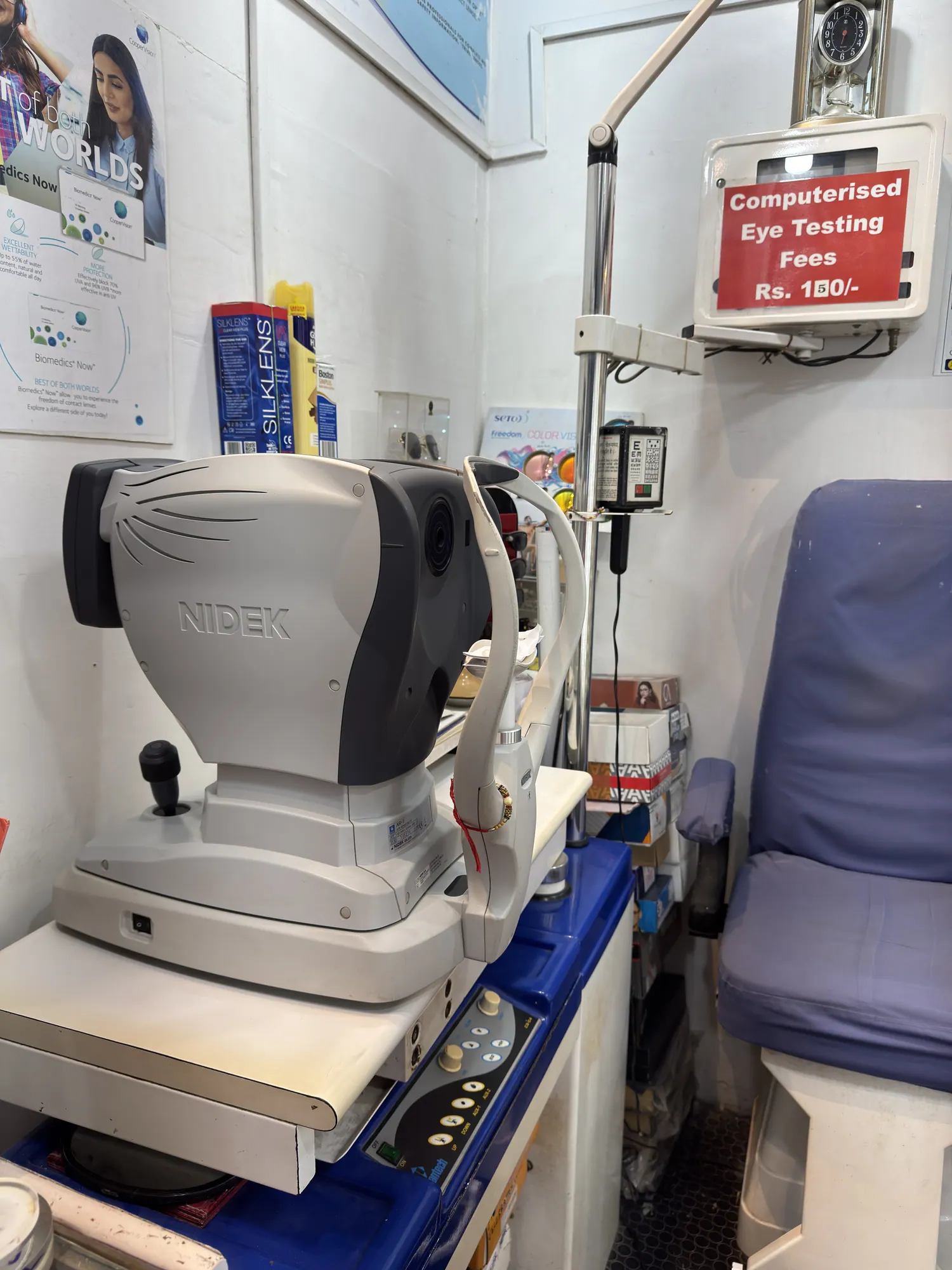 The autorefractor in the eye testing room at Ami Optics, Virar East, beside the eye test fee board